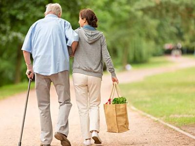 Caregiver – woman helping senior man with shopping Caregiver – woman helping senior man with shopping